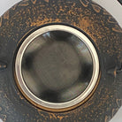 Close-up of a rusty metal filter with a white background